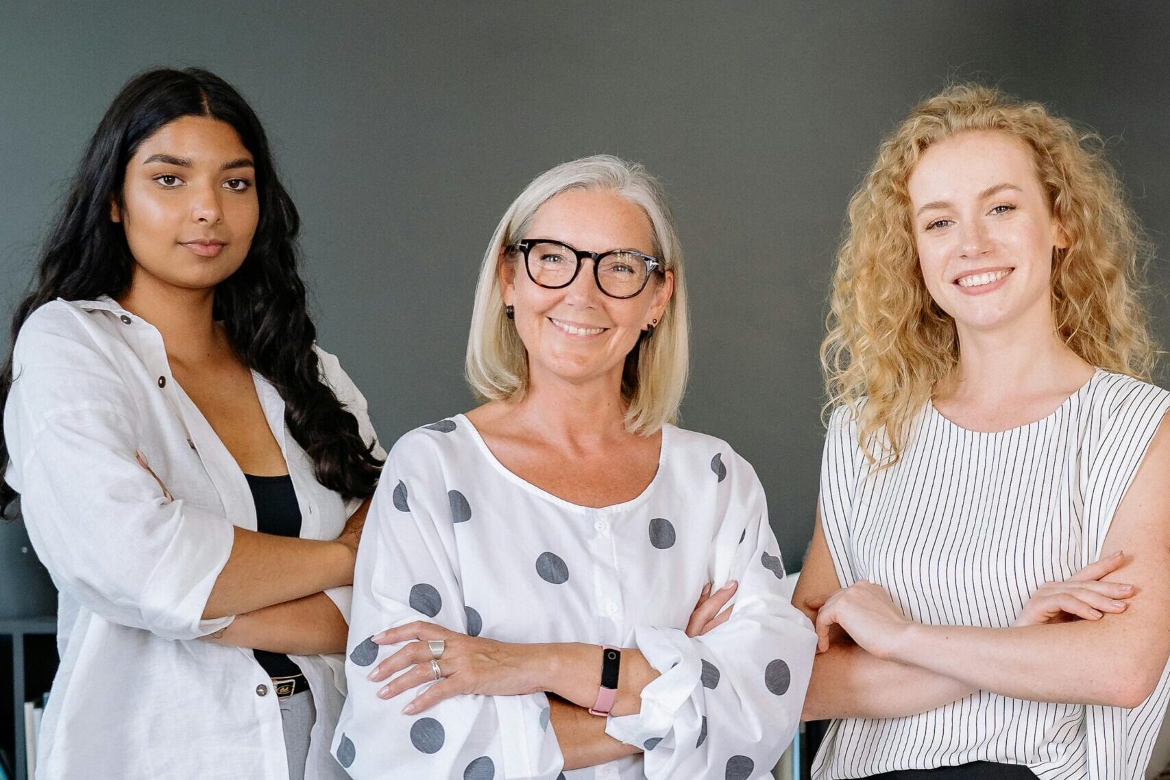 Confident and diverse group of businesswomen standing together in a modern office.